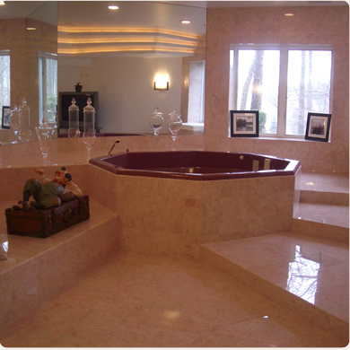 A Marble Floor Bathroom With a Burgundy Bathtub
