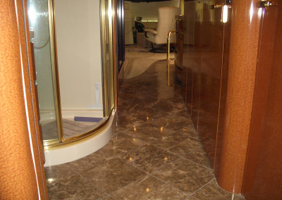 A Shower Area With Brown Color Tiles